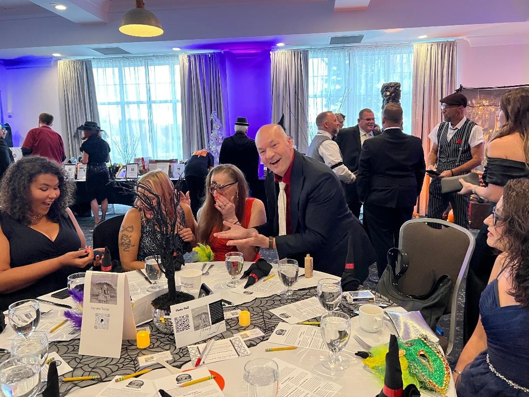 Angels Among Us Gala — guests laughing at dinner table
